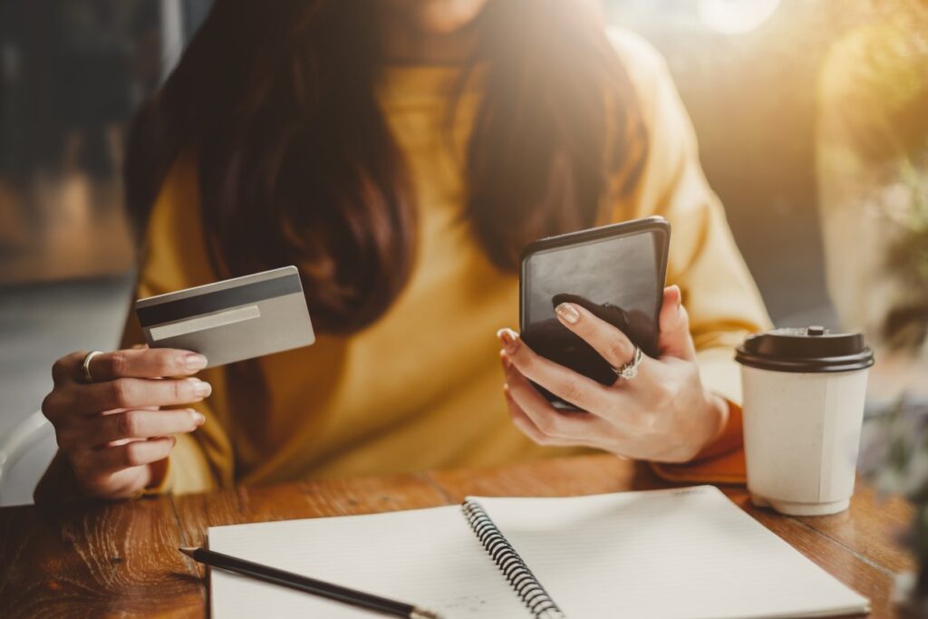 woman making a payment with a credit card on cell phone