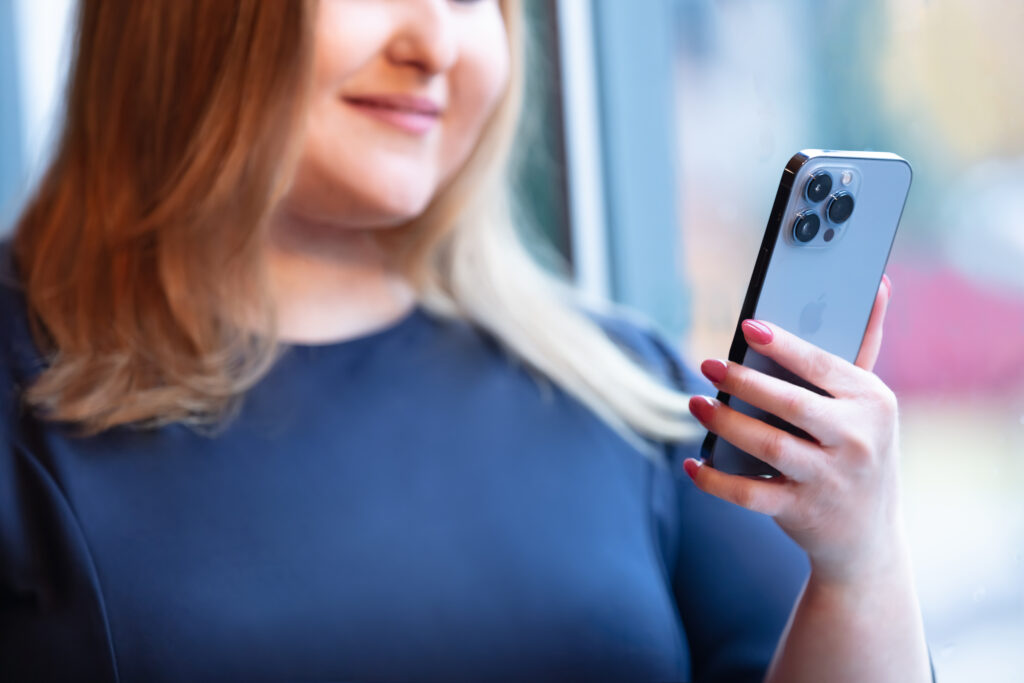 detailed view of young woman looking at phone