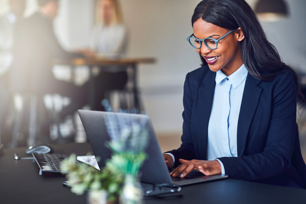 Smiling young African American Businesswoman working on a laptop