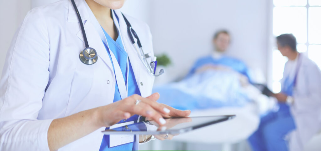 female doctor using tablet computer in hospital lobby