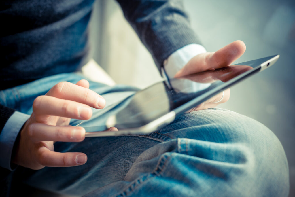 close up hands multitasking man using tablet