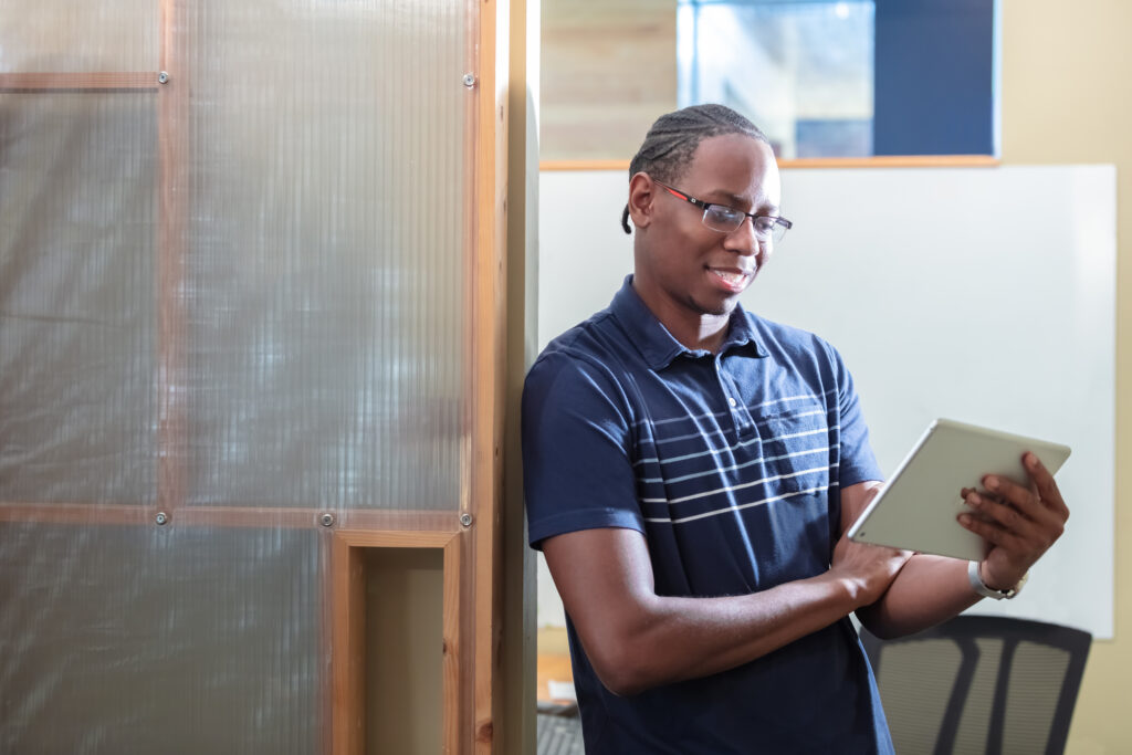 African American man holding tablet