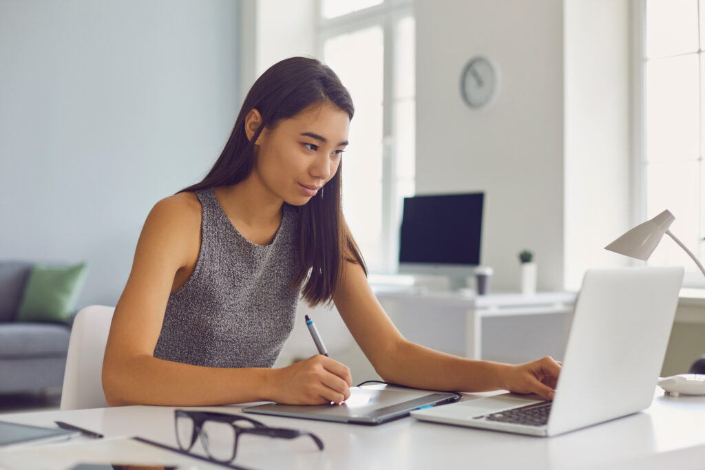 talented asian female graphic designer or digital artist working