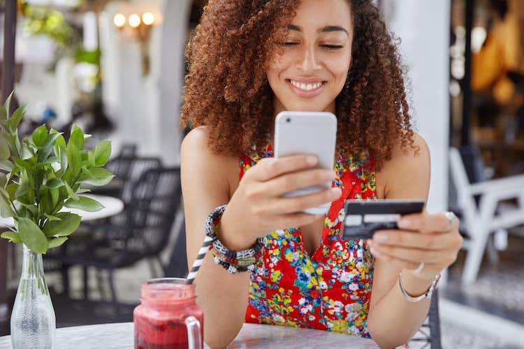 Women with phone holding card
