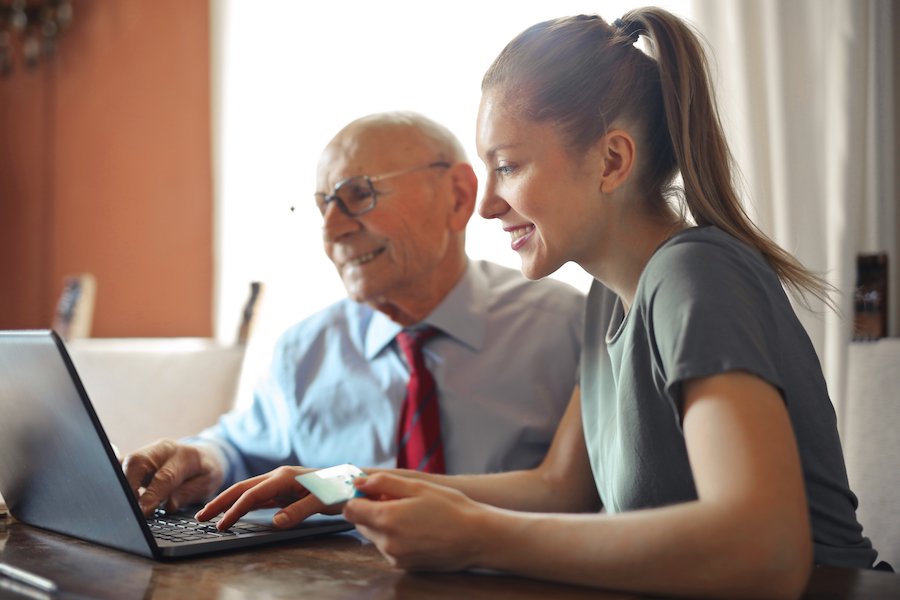 Older person and Younger person looking at screen